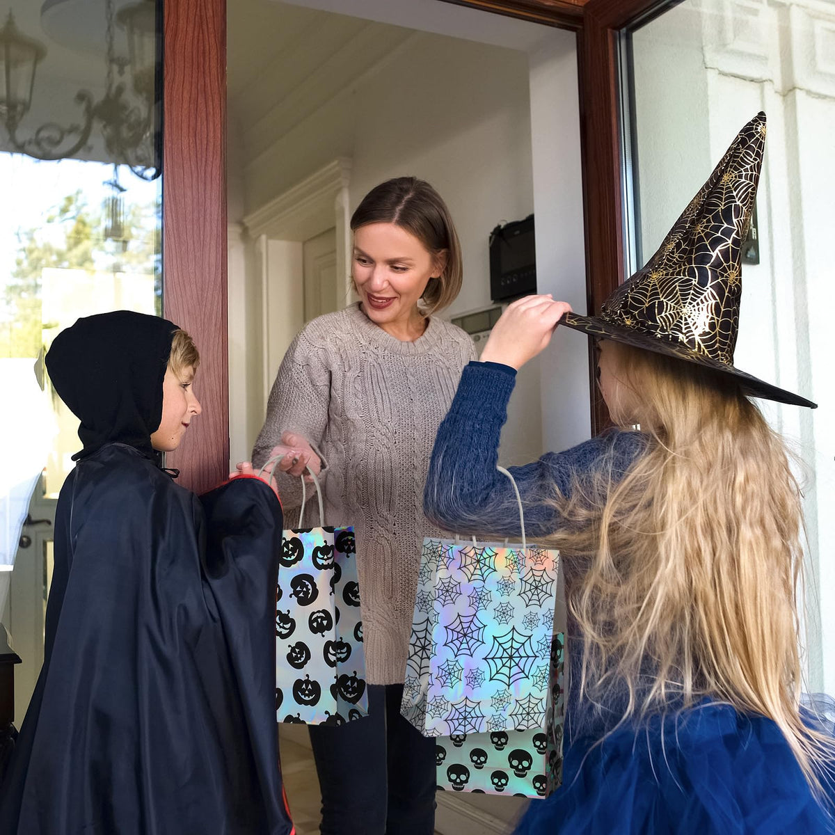 Paterr 24 Pcs Iridescent Halloween Paper Bags Holographic Bat Pumkin Skeletons Pumpkins Spider Webs Trick or Treat Reusable Gift Bags for Halloween Party Supplies Favors(Classic Patterns)